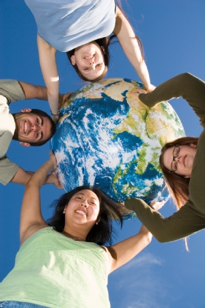 Picture of four students holding an inflatable globe of the Earth. Photograph/video taken prior to COIVD-19. UCSC is following all CDC guidelines. 